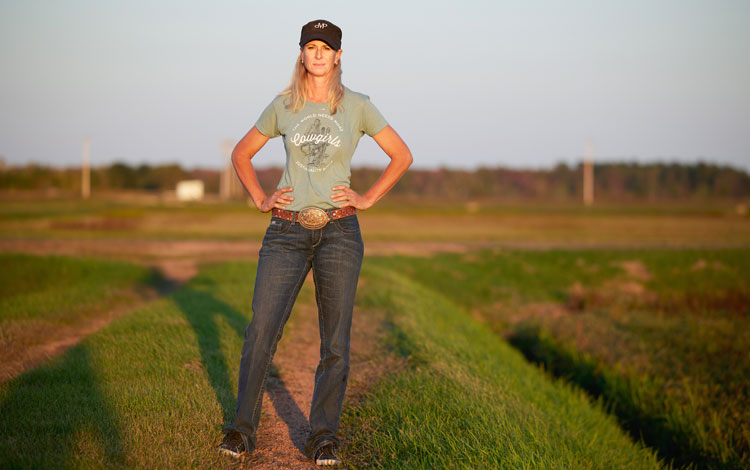 Barrel Racer, Sherry Cervi standing in her family's cranberry field. 